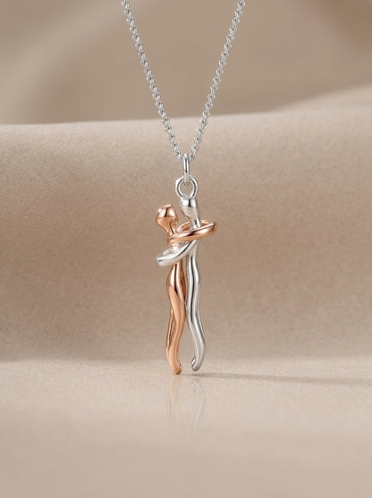 Always Close embrace necklace on a neutral background