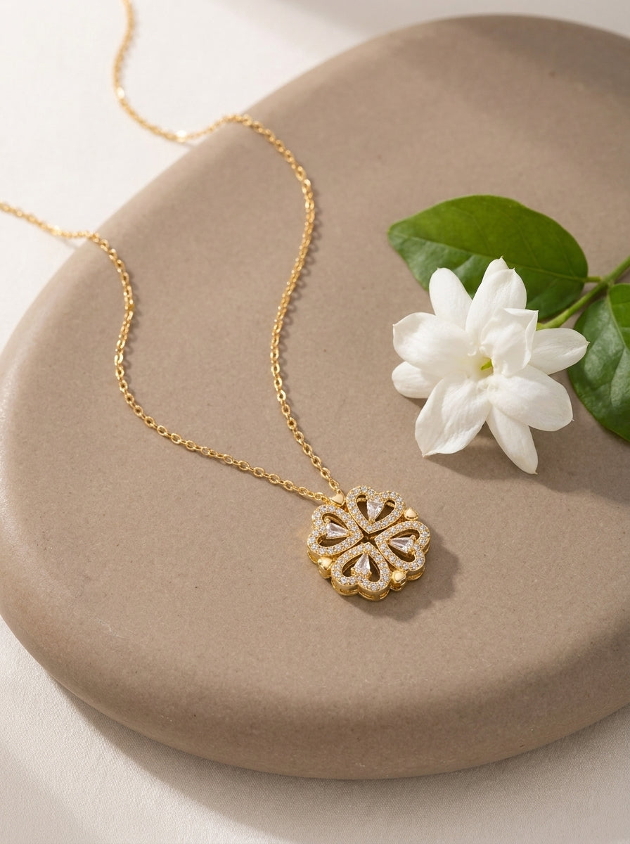 Gold Love in Bloom clover necklace on stone
