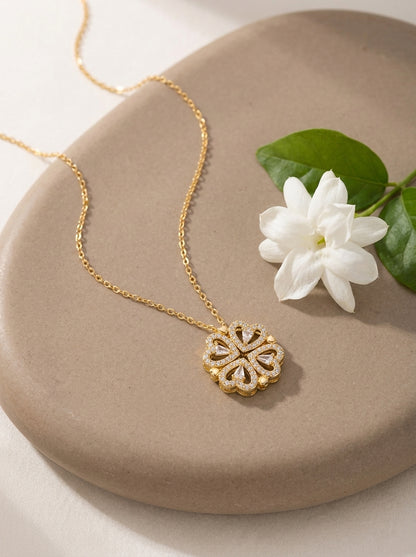 Gold Love in Bloom clover necklace on stone
