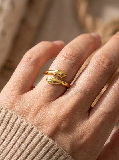 Gold Embrace Hug Ring shown on hand