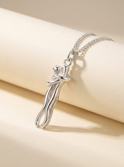 Silver Always Close hug necklace on an ivory surface